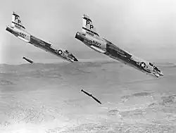 U.S. Navy F-8J Crusaders drop bombs (1972).