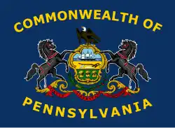 2007–2010 proposal,[13][14] adding the words "Commonwealth Of" to the top and "Pennsylvania" to the bottom of the flag in yellow silk, and arching the lettering around the coat of arms