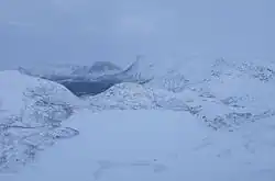 Light shines in the Polar Night. Flurries of snow above the tree lakes Nevervatnet, Røyrvatnet and Straumvatnet. Fauske and Sørfold, Nordland, Norway.