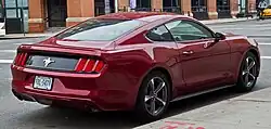 Rear three-quarters view of a light red coupe
