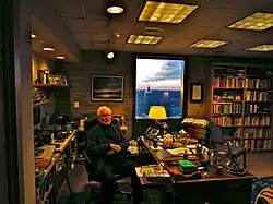 Theodore Hesburgh sitting at his desk