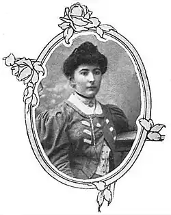B&W oval portrait photo of a middle-aged woman with her hair in an up-do