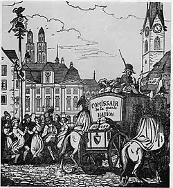 A population celebrates while soldiers escort a secured wagon of material through the city. A pair of twin spires tower above the city, indicating the city is Zurich, Switzerland.
