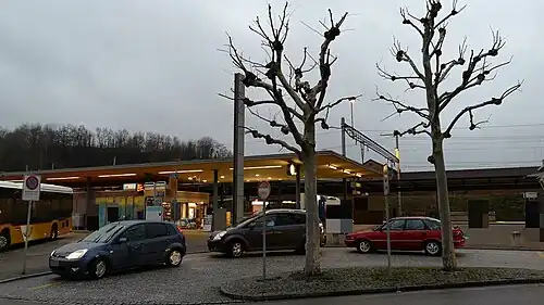 Cars pulled up in front of a platform with canopy