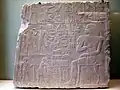 Slab stela, multiple use of the "arms-in-embrace" for supplying provisions for the Afterlife