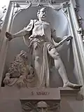 Statue of Mark the Evangelist with a lion, decorated with drapes, volutes, and cherubs.