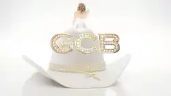 A large white hat with gold trim.