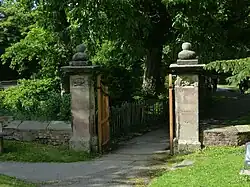 A pair of gateposts with carved skulls
