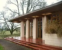 Gordon House's living room exterior, with full-height floor-to-ceiling windows