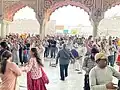 Devotees gathering for satsang inside the temple