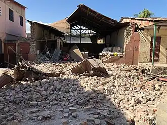 Damage to a building. Rubble strewn all over.