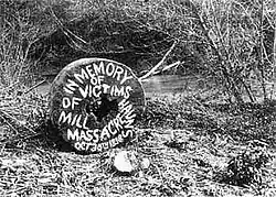 a round millstone painted with the words "in memory of victims of haun's mill massacre"