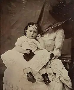 Mother only partly hidden in this portrait to comfort child​​‌