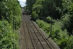 High Royds Hospital Railway junction location in Menston, West Yorkshire; the track curved in on the right and ran under the bridge that the photographer is on