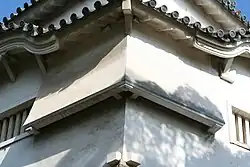 Photo of two angled chutes or "stone drop windows" on a castle structure