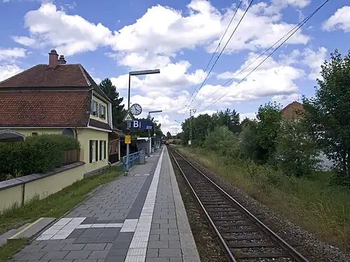 Two-story building next to side platform