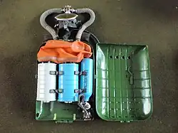 IDA-71 with lid of casing opened showing interior with counterlung, scrubber canisters and oxygen supply cylinder and regulator