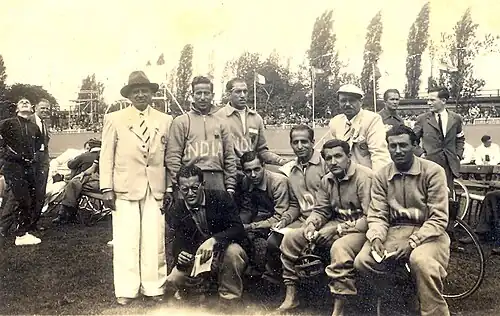India cyclists at the 1948 Olympics (standing, l to r: Bhoot (in jacket with hat), Adi Havewala, x, Nariman Saugar (in jacket with cap); seated, l to r: x (in blazer), x, Malcolm, Mehra, x)