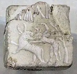 Fighting scene between a beast and a man with horns, hooves and a tail, who has been compared to the Mesopotamian bull-man Enkidu.[7][15][9] Indus Valley civilization seal.