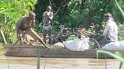 Small traders transport charcoal on a rickety boat across River Kagera in Kajaho, Isingiro District on the Uganda-Tanzania border.