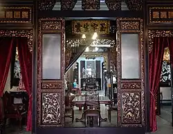 Image 137Inside the former house of a Peranakan (Baba-Nyonya or 峇峇娘惹) in Malacca which has now been converted into a museum, a Nyonya can be seen sitting inside wearing the traditional kebaya[broken anchor]. (from Malaysian Chinese)