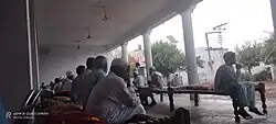 Inside the Hujra: community members gather for traditional three-day prayers after a death.