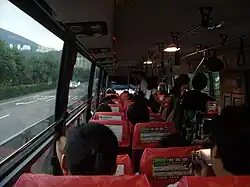 High-floor coach in South Korea, unusually fitted with grab handles and poles