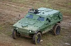 A green unarmed VBL moves in the mud