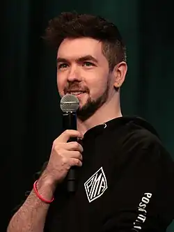 McLoughlin holding a microphone
