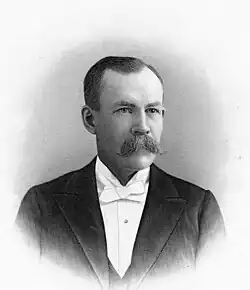 A portrait of Rawlins in his 40s dressed in formal wear.