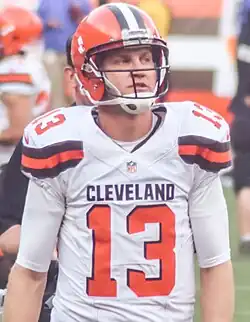 A photo of a helmeted football player in a white #13 jersey with the words "Cleveland" on it