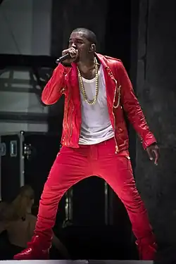 A Man wearing a red outfit and is holding a microphone