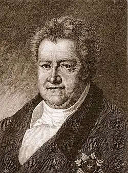 Black and white print of a man with a double-chin wearing a dark coat with a decoration on the breast.