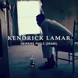 In this single cover, an empty room with a man sitting on a chair with a bottle of liquor on the floor.