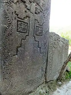 Another series of khackhars on the south side of the monastery, with one stone broken (2014 photo)