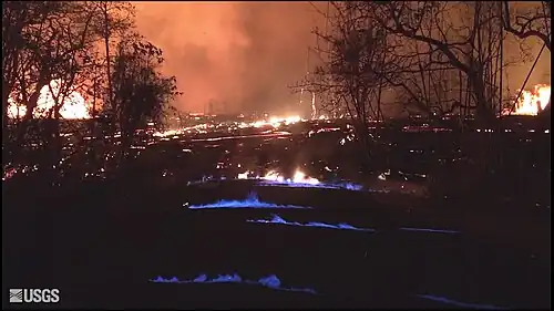 Blue flames from burning methane gas in Leilani Estates, on 22 May 2018, 11:30&nbsp;p.m. HST.[41]