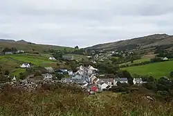 View from the monastic site at the old church down to the village, looking east. The R263 is to be seen as it leaves Kilcar in direction to Killybegs
