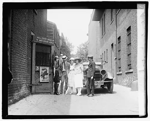 A flapper and patrons in front of The Krazy Kat, a Jazz Age speakeasy, in 1921. Critics touted Fitzgerald's This Side of Paradise as turning the national spotlight on the Jazz Age generation⁠—those Americans younger than Fitzgerald who had been adolescents during World War&nbsp;I and whom Fitzgerald regarded as the true "lost" generation.