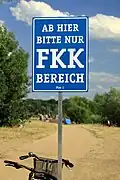 Signpost: From here public nude bathing only (FKK)