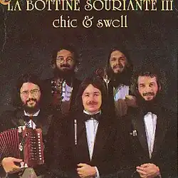 Photograph of La Bottine Souriante, posing with instruments