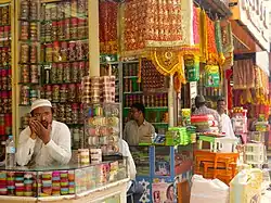 four men in traditional bridalwear shops in the market