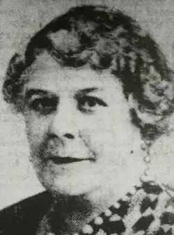 Poor-quality microfilm of newsprint copy of original photograph of a three-quarter profile of a middle-aged woman with bobbed hair and red lipstick.