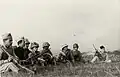 Colonial troops of the Thang-long Regiment, national guard, about to go into battle, December 1946. One of them has a Japanese helmet.