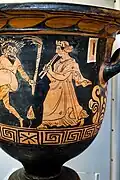A wreathed Phlyax with torches dances to a woman playing the aulos, c. 340–320 BC