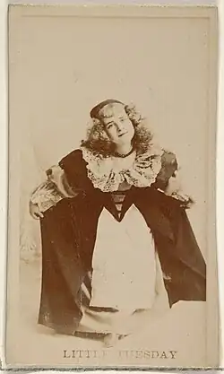 Girl wearing long dress, curtseying.