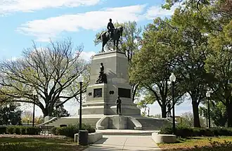 A bronze equestrian statue of a general, positioned atop a granite pedestal