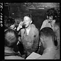 Paul Pennoyer with his back against the board on the USS Monterey in 1944.[12]