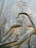 Bust depiction of Seshat recording the king's life on the palm rib. Thoth (not pictured) is doing likewise across from her. Sunken relief in granite from the back of the throne of the statue of Ramesses II, in the Amun temple at Luxor (c. 1250 BCE).