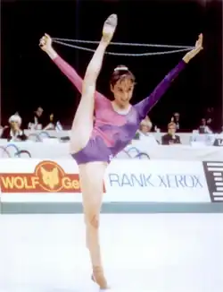 Ferrández stands in a split with the rope held between her hands