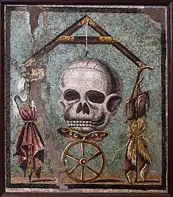 Roman mosaic representing the Wheel of Fortune which, as it turns, can make the rich poor and the poor rich; in effect, both states are very precarious, with death never far and life hanging by a thread: when it breaks, the soul flies off. And thus all are made equal. (Collezioni pompeiane. Museo Archeologico Nazionale di Napoli)